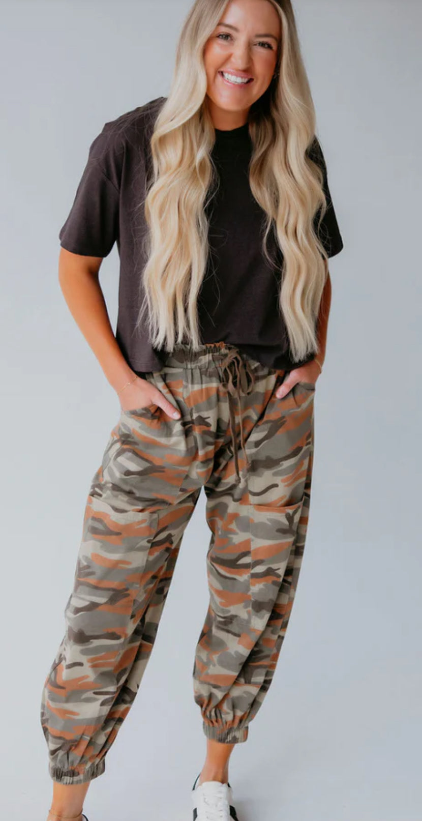 Sage, olive, and rust camo pants with elastic cuffs and waist