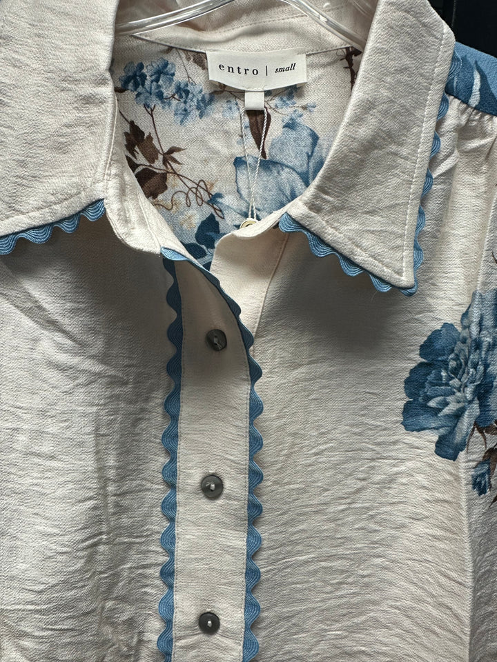 button up long sleeve blouse with blue rickrack around collar cream poly blouse with blue floral sleeves